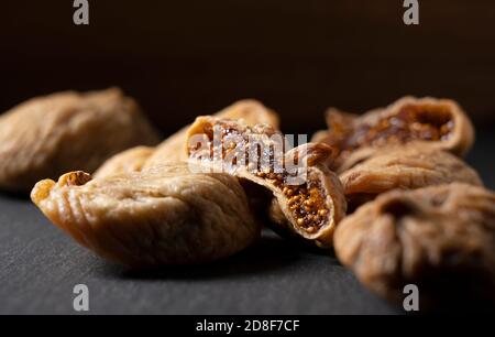 Close up of dried figs placed on a black background Stock Photo