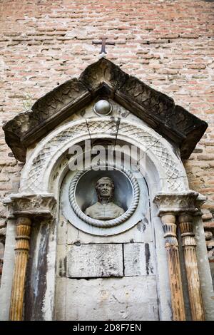 Tomb outside a crumbling abandoned church in central Tbilisi, Georgia, Caucasus, Eastern Europe. Stock Photo