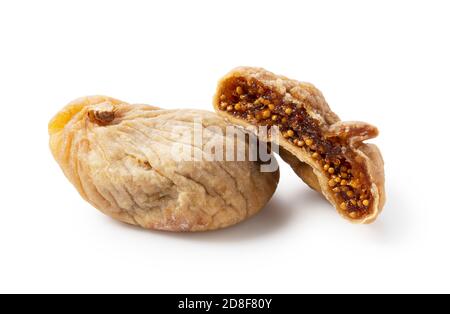 Dried figs and dried figs cut in half on a white background Stock Photo