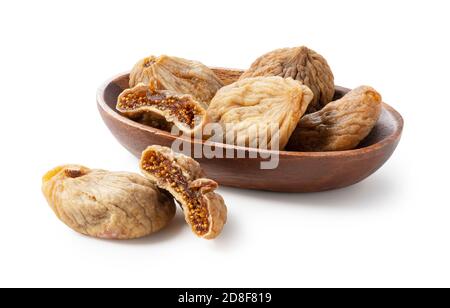 Dried figs and dried figs cut in half in a wooden plate on a white background. Stock Photo