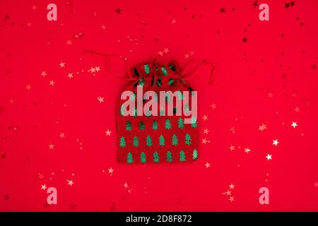 Christmas bag toy minimal composition. Christmas textile decorations on red surface. Top view, flat lay Stock Photo