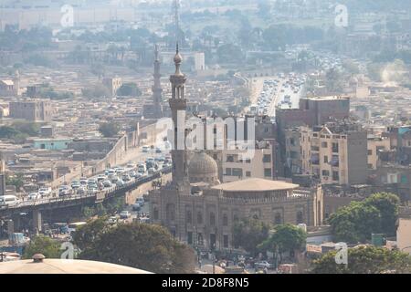 View of misty of city of Cairo in Egypt, due to traffic pollution, over rooftop slums and mosques Stock Photo