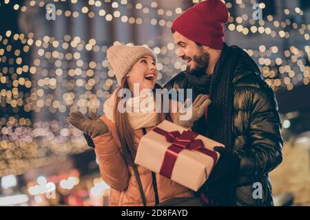 Photo of two people amazed girl get from loving husband dream gift box under evening x-mas outside illumination Stock Photo