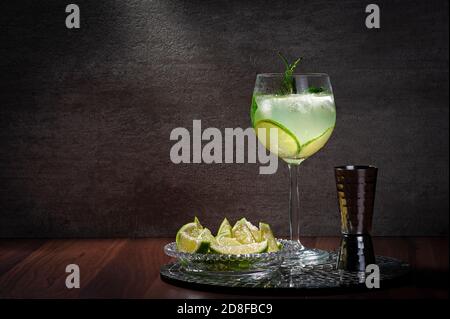 lemon cocktail on a mirror tray concrete background, copy space. Stock Photo