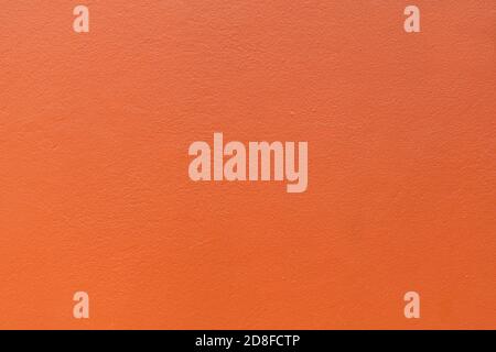 Plastered wall painted orange colour background. Stock Photo