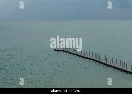 The buoy walkway extends into the sea. Stock Photo