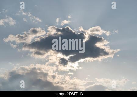 Big grey cloud hiding the sun. Magnificent panoramic cloudscape. Fluffy cumulonimbus cloud on blue sky. Stock Photo