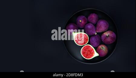 Fresh ripe figs on dark Background. Beautiful blue violet figs with empty copyspace close up. Food photo Stock Photo