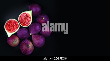 Fresh ripe figs on a black plate over dark background,  top view. Copy space Stock Photo