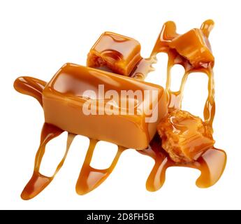 Composition of soft caramel candies isolated on white background, top view. Sweet caramel pieces with sauce or  maple syrup Stock Photo