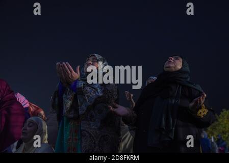 Srinagar, India. 30th Oct, 2020. Kashmiri Muslim women pray outside Hazratbal Shrine on the eve of Eid-Milad-un-Nabi in Srinagar.Amid Coronavirus pandemic thousands of Muslim devotees gathered at the Hazratbal shrine in summer capital Srinagar, which houses a relic believed to be a hair from the beard of Prophet Muhammed, to offer special prayers on the occasion of the Eid-e-Milad-un-Nabi, the birth anniversary of Islamic Prophet Muhammad PBUH. Credit: SOPA Images Limited/Alamy Live News Stock Photo