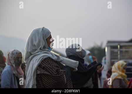 Srinagar, India. 30th Oct, 2020. A Kashmiri Muslim woman raises her hands while beseeching for blessings on the eve of Eid-Milad-un-Nabi outside Hazratbal Shrine in Srinagar.Amid Coronavirus pandemic thousands of Muslim devotees gathered at the Hazratbal shrine in summer capital Srinagar, which houses a relic believed to be a hair from the beard of Prophet Muhammed, to offer special prayers on the occasion of the Eid-e-Milad-un-Nabi, the birth anniversary of Islamic Prophet Muhammad PBUH. Credit: SOPA Images Limited/Alamy Live News Stock Photo