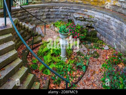 Sweet Spring in Eureka Springs is Sweet Spring Park basin bowl collecting water and the beautiful fl Stock Photo