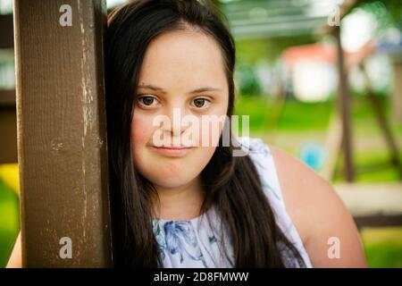 A Portrait of trisomie 21 adult girl outside at sunset Stock Photo - Alamy