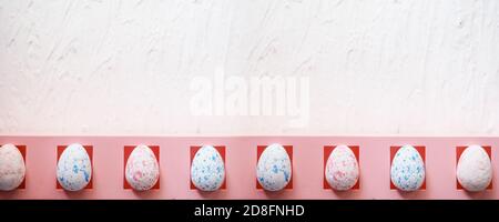banner easter, holidays and tradition concept - row of colored artificial eggs on pink. Stock Photo