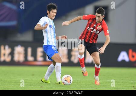 Brazilian football player Oscar dos Santos Emboaba Junior, better known as simply Oscar, of Shanghai SIPG F.C., right, attempts to steal the ball duri Stock Photo