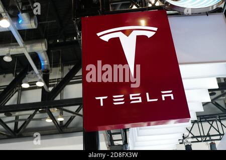 In this unlocated and undated photo, the logo of Tesla, an American electric vehicle and clean energy company, is seen its booth during an exhibition. Stock Photo