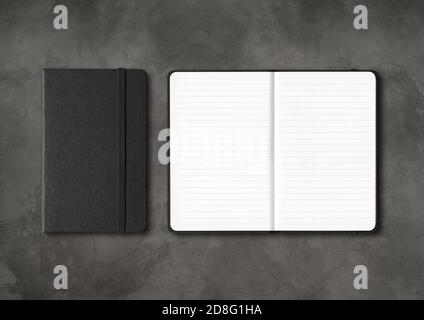 Black closed and open lined notebooks mockup isolated on dark concrete background Stock Photo