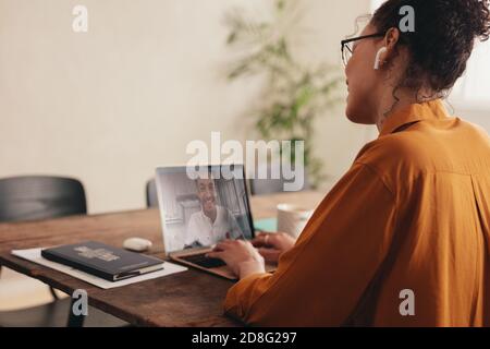 Couple separated by the pandemic. Binational couple in a long distance relationship doing a video call. Stock Photo