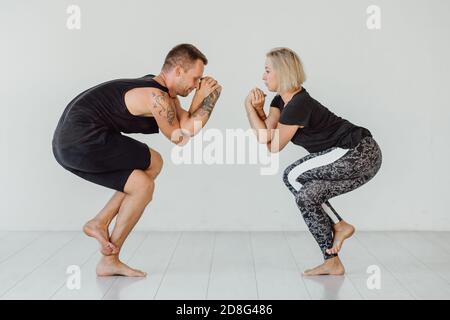 Man and woman meditate in yoga pose. Woman and man doing sport exercise. Stock Photo