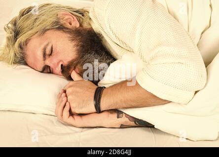 Having nap. Sweet dreams. Good night. Mental health. Practice relaxing bedtime ritual. Man with sleepy face lay on pillow. Fast asleep concept. Man with beard relaxing. Hipster with beard fall asleep. Stock Photo
