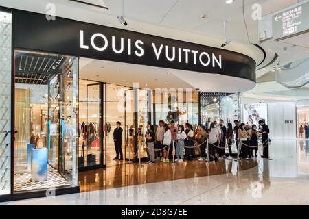 Row Of Waiting People Before Louis Vuitton Shop Stock Photo