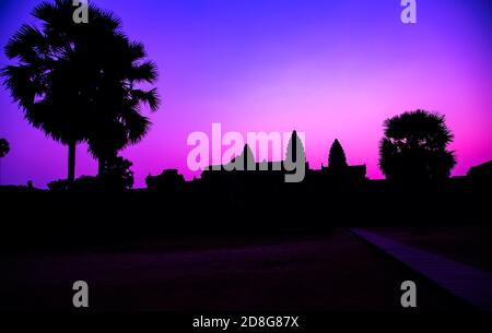 Panorama Mist sunrise tropical morning violet tourist attraction ancient temple facade silhouette of the Angkor Wat temple in Angkor Archaeological Pa Stock Photo