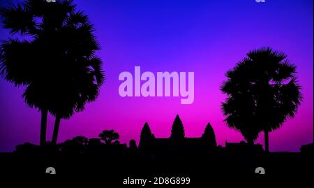 Sunrise Purple temple facade silhouette Palm trees of the UNESCO Angkor Wat temple in Angkor Archaeological Park near Siem Reap in Cambodia. Stock Photo