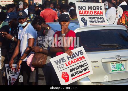 Protesters hold placards during #EndSARS protests against police brutality in Lagos Nigeria on October 15, 2020. Stock Photo