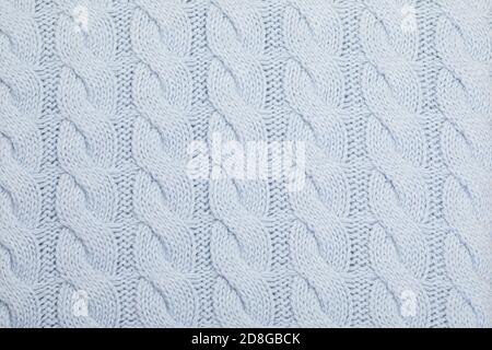 Real blue knitted fabric with cable pattern textured background Stock Photo