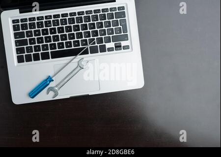 wrench and screwdriver, on blue background.Technical support concept Stock Photo