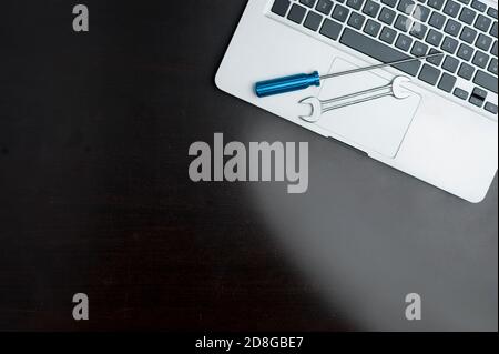 wrench and screwdriver, on blue background.Technical support concept Stock Photo