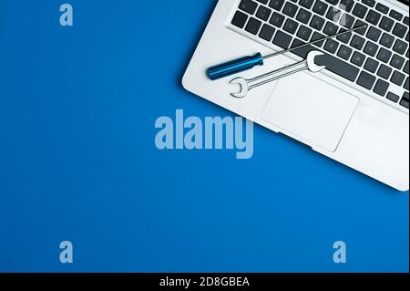 wrench and screwdriver, on blue background.Technical support concept Stock Photo