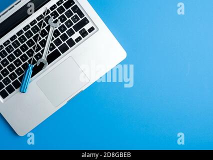 wrench and screwdriver, on blue background.Technical support concept Stock Photo