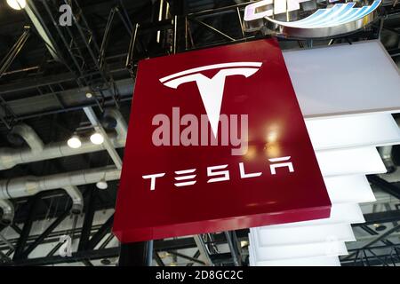 In this unlocated and undated photo, the logo of Tesla, an American electric vehicle and clean energy company, is seen its booth during an exhibition. Stock Photo