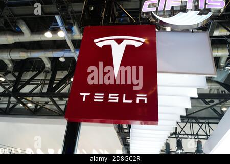 In this unlocated and undated photo, the logo of Tesla, an American electric vehicle and clean energy company, is seen its booth during an exhibition. Stock Photo