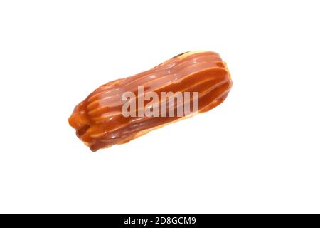 Eclair cake covered with salted caramel with caramel custard filling isolated on white background Stock Photo
