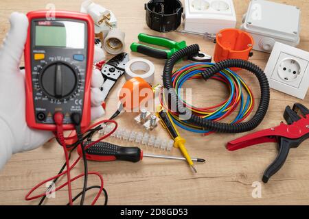 Tools for electrician needs: shocket multimeter, voltage testers, wire strippers, pliers, Stock Photo