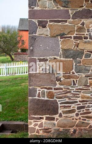 Hefty colorful cornerstones on colonial Pennsylvania stone home Stock Photo