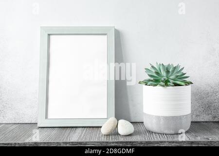 Home interior with mock up photo frame on wooden table with echeveria in ceramic pot. Home gardening. Template - Image Stock Photo