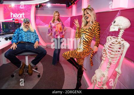 Amanda Holden, Jamie Theakston and Ashley Roberts present the Heart Breakfast show dressed up as the cast of Tiger King, at their studios in Leicester Square, London. Picture date: Friday October 30, 2020. Photo credit should read: Matt Crossick/Empics Stock Photo