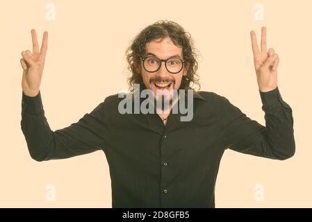 Happy handsome Caucasian man giving peace sign with both hands Stock Photo