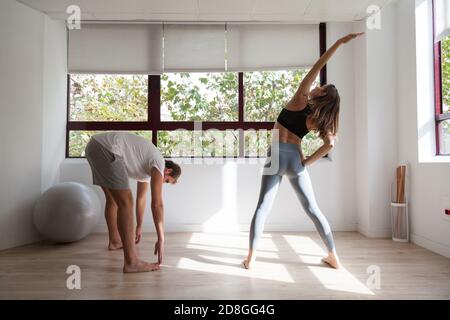 One young couple doing exercise at the gym Stock Photo