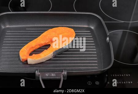Non-stick frying pan on induction hob. Cooking concept. Stock Photo