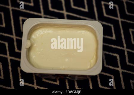 yogurt in a plastic cup top view. baby food in disposable cups. Yogurt in a plastic container. Healthy diet Stock Photo