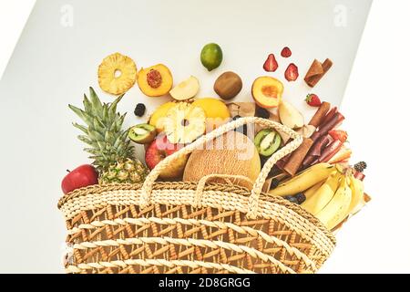Ingredients for making homemade pastilles. Fresh fruits in a wicker eco-friendly bag on white background. Sugar free and healthy eating concept. Stock Photo