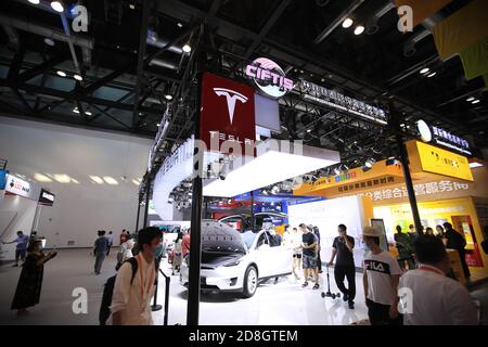 In this unlocated and undated photo, the logo of Tesla, an American electric vehicle and clean energy company, is seen its booth during an exhibition. Stock Photo