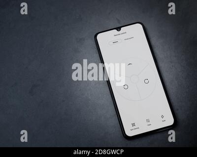 Lod, Israel - July 8, 2020: Roborock app launch screen with logo on the display of a black mobile smartphone on dark marble stone background. Top view Stock Photo