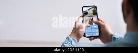 Smart Home CCTV Security On Mobile Phone Or Smartphone Stock Photo