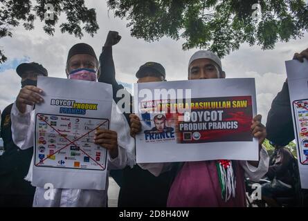 Malang, East Java, Indonesia. 30th Oct, 2020. Some protesters carried posters to boycott French products in Indonesia. Accompanied by the action of sticking up posters of the flag and face of french president Emmanuel Macron on the highway. In protest of French President, Emmanuel Macron's statement which he considered insulting Islam and Prophet Muhammad SAW in Malang, East Java, Indonesia, on October 30, 2020. Credit: Aman Rochman/ZUMA Wire/Alamy Live News Stock Photo